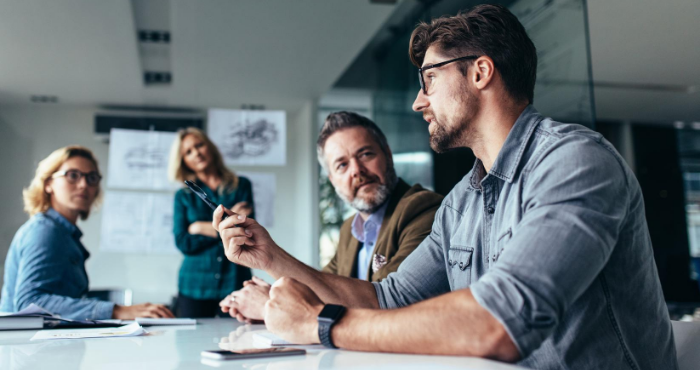 young-male-professional-in-group-office-meeting