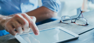 man-tapping-studying-on-tablet-computer