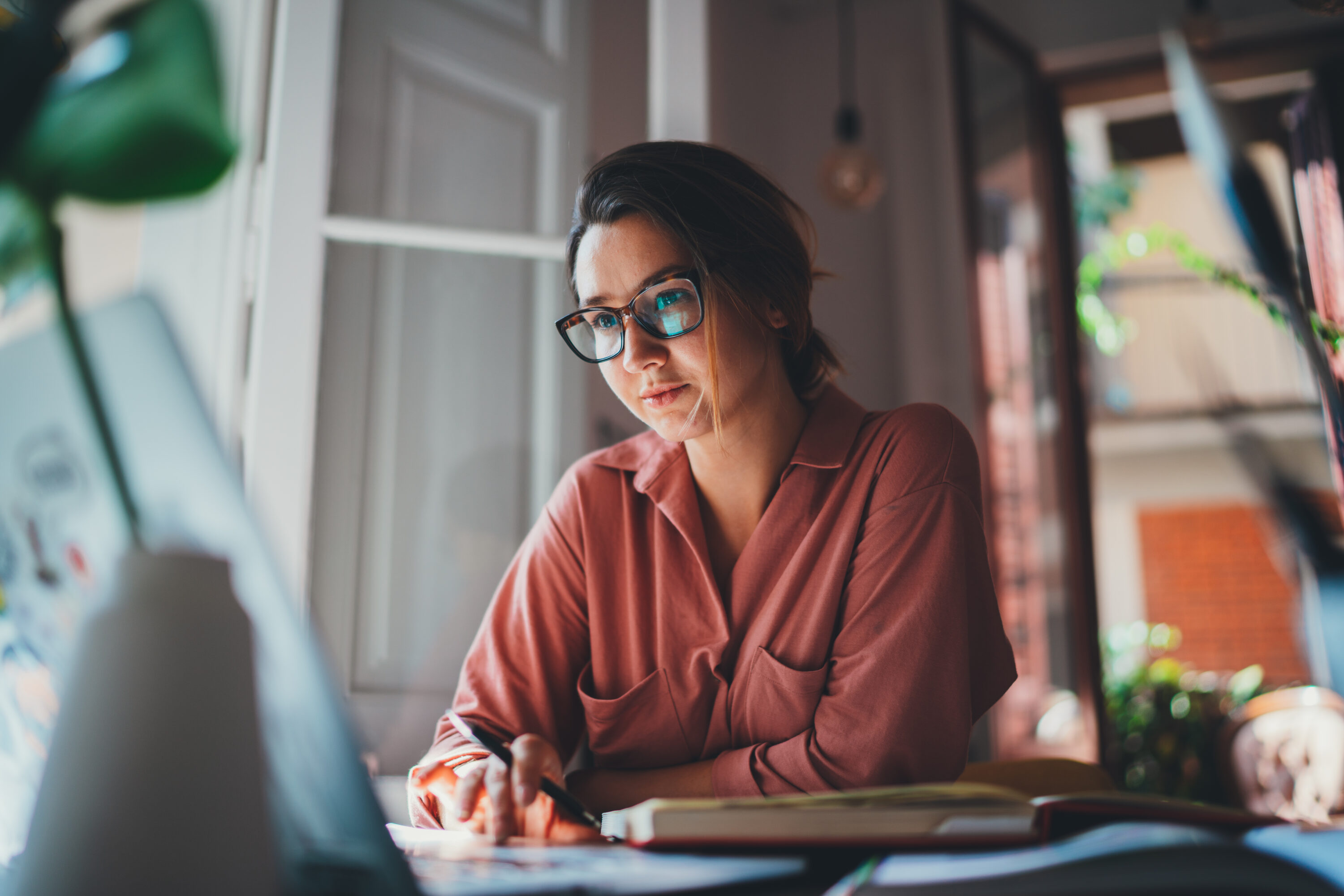 Pretty young woman an advertising copywriter in eyeglasses worki Pretty young woman an advertising copywriter in eyeglasses worki
