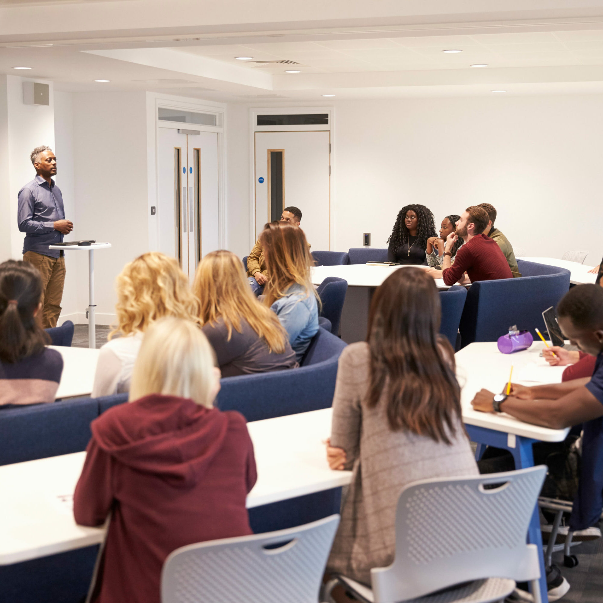 University students study in a classroom with male lecturer