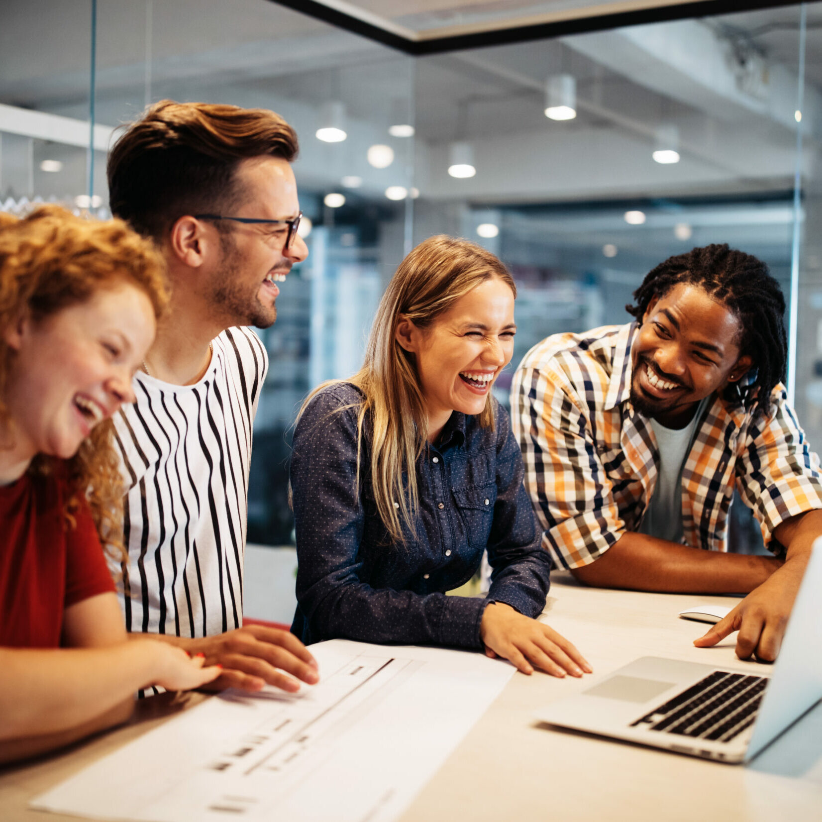 Happy creative designers, business people brainstorming and working at workplace