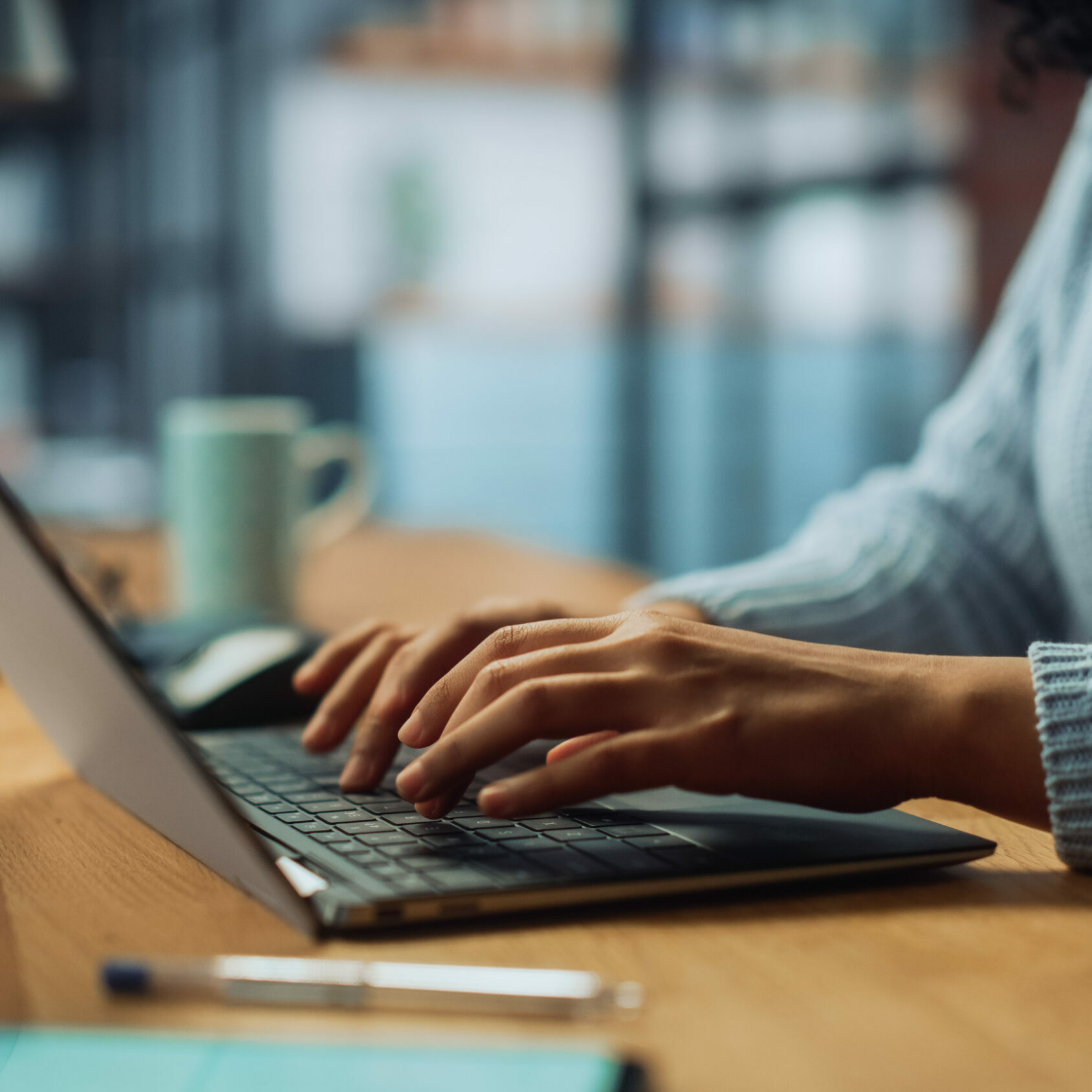 Close Up on Hands of a Female Specialist Working on Laptop Computer at Cozy Home Living Room while Sitting at a Table. Freelancer Woman Chatting Over the Internet on Social Networks.