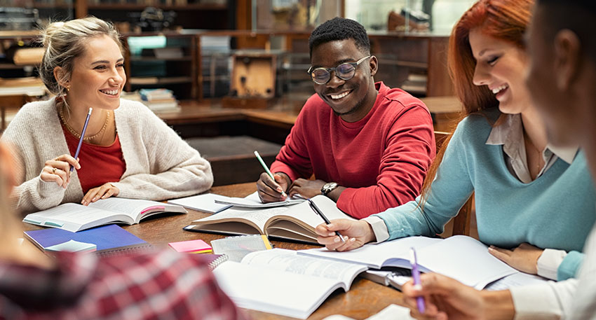 A group of law students studying with guides in the law library