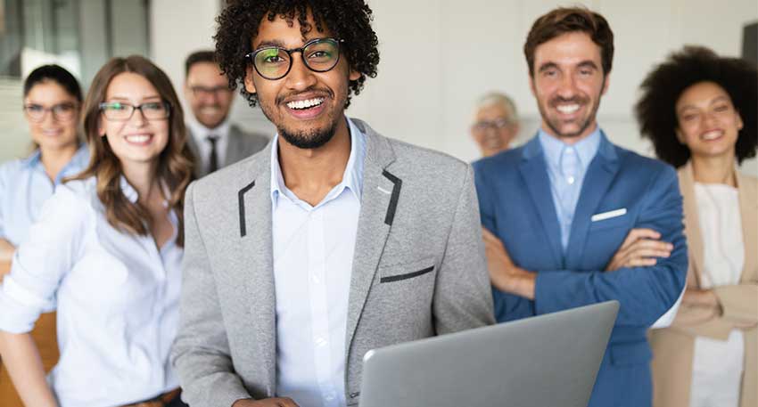 A group of current and former law students smile at the camera