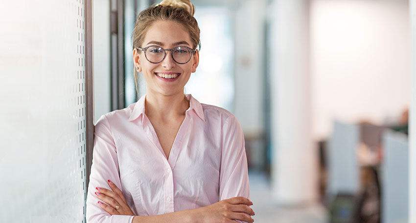 A female lawyer stands confidently at a law firm