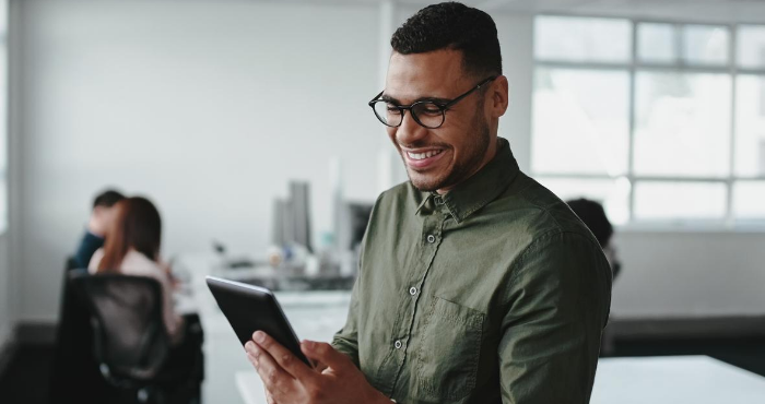 young-male-lpc-student-smiling-looking-at-tablet