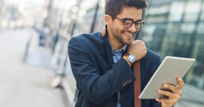 young-male-professional-leaving work-whilst-preparing-for-the-sqe-on-his-tablet-on-the-go